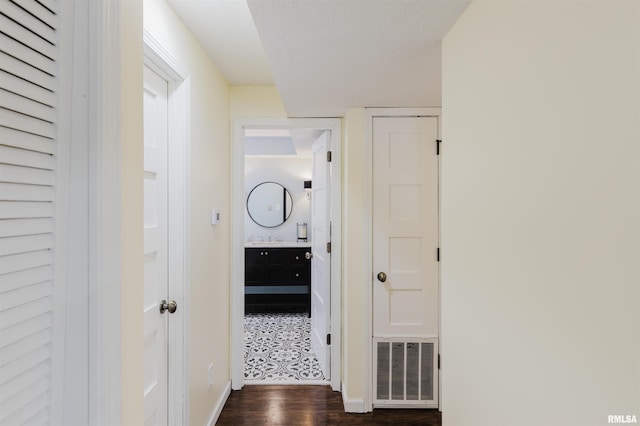 12897 Egypt Shores Dr, Creal Springs, IL 62922 - hallway with dark wood-style floors, baseboards, and a sink