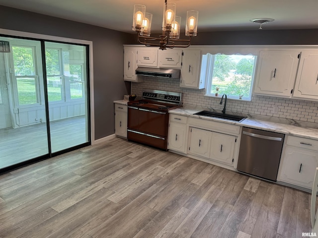 6984 Washington St, Mulkeytown, IL 62865 - kitchen with dishwasher, range with electric stovetop, a sink, under cabinet range hood, and a chandelier