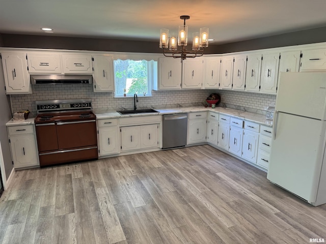 6984 Washington St, Mulkeytown, IL 62865 - kitchen with freestanding refrigerator, range with electric cooktop, stainless steel dishwasher, under cabinet range hood, and a sink