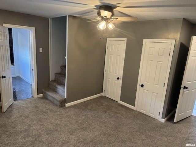 6984 Washington St, Mulkeytown, IL 62865 - empty room featuring ceiling fan, dark colored carpet, stairs, and baseboards