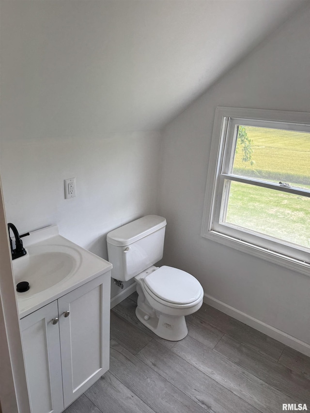 6984 Washington St, Mulkeytown, IL 62865 - half bath featuring lofted ceiling, toilet, vanity, wood finished floors, and baseboards