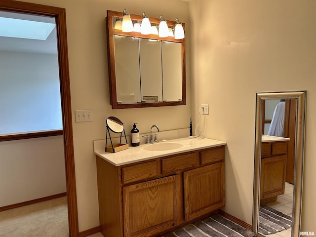 108 N Gordon Ln, Carbondale, IL 62901 - bathroom featuring vanity, a skylight, and baseboards