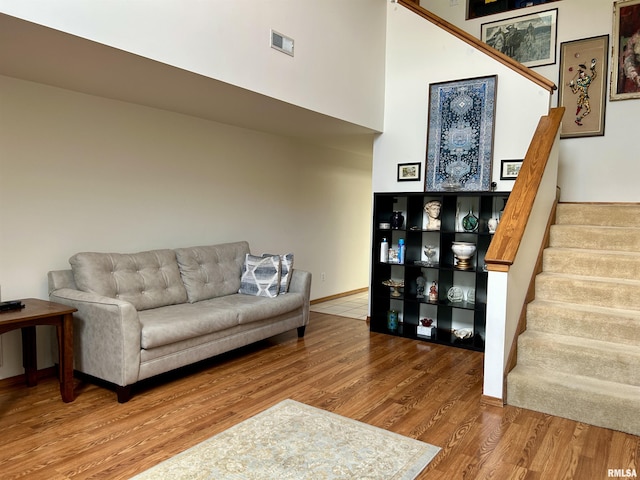 108 N Gordon Ln, Carbondale, IL 62901 - living room featuring wood finished floors, stairs, and a towering ceiling