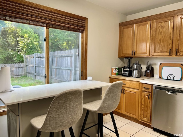108 N Gordon Ln, Carbondale, IL 62901 - kitchen with stainless steel dishwasher, light countertops, and a kitchen bar
