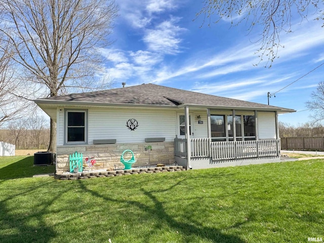 310 Williford Rd, Jonesboro, IL 62952 - view of front facade featuring a front lawn, roof with shingles, and central air condition unit