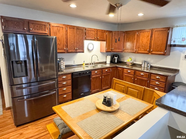 310 Williford Rd, Jonesboro, IL 62952 - kitchen featuring stainless steel fridge, black dishwasher, a sink, dark countertops, and brown cabinets