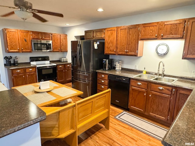 310 Williford Rd, Jonesboro, IL 62952 - kitchen with stainless steel appliances, a sink, dark countertops, light wood-style floors, and recessed lighting