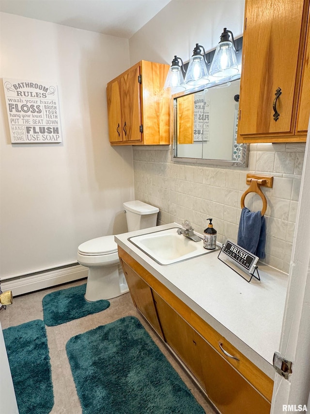 310 Williford Rd, Jonesboro, IL 62952 - bathroom with a baseboard radiator, toilet, decorative backsplash, and vanity