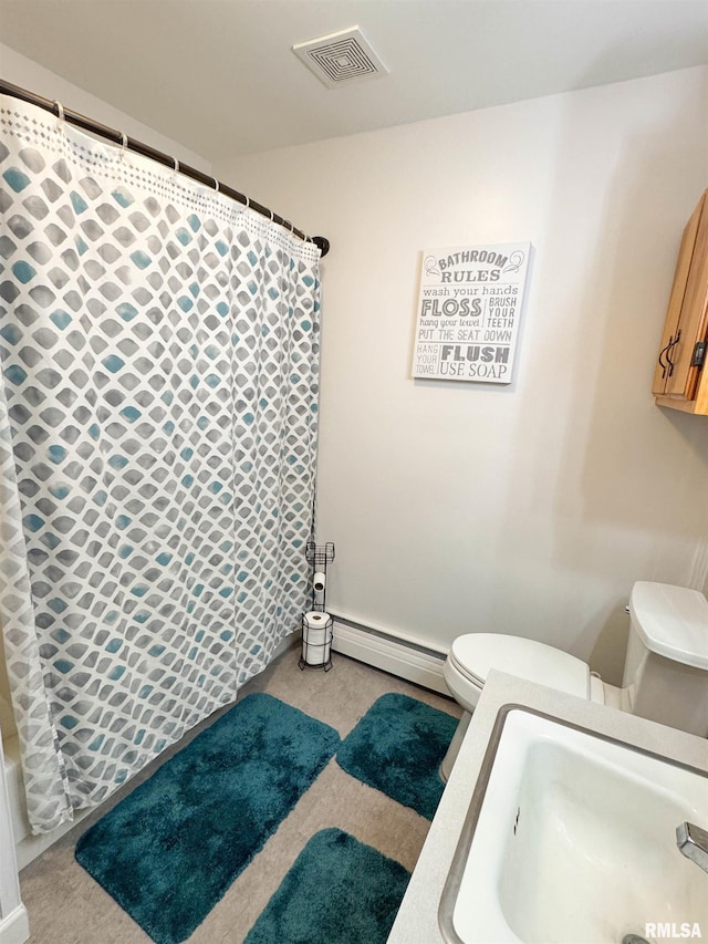 310 Williford Rd, Jonesboro, IL 62952 - bathroom featuring toilet, baseboard heating, a shower with shower curtain, and a sink
