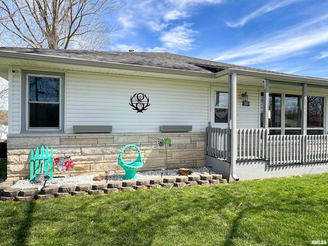 310 Williford Rd, Jonesboro, IL 62952 - view of front facade featuring stone siding, a porch, roof with shingles, and a front lawn