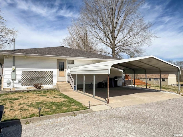 310 Williford Rd, Jonesboro, IL 62952 - view of front of property featuring a detached carport, a front yard, roof with shingles, and gravel driveway