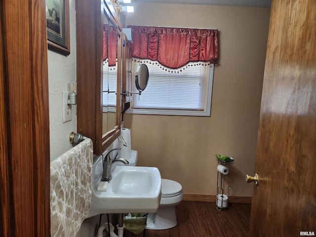 605 Pace Ave, Mount Vernon, IL 62864 - bathroom featuring baseboards, wood finished floors, healthy amount of natural light, and toilet
