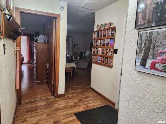 605 Pace Ave, Mount Vernon, IL 62864 - corridor featuring a textured wall, wood finished floors, baseboards, and a textured ceiling