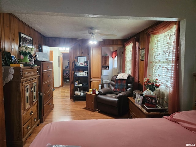 605 Pace Ave, Mount Vernon, IL 62864 - bedroom with wood walls, light wood-style flooring, and a textured ceiling
