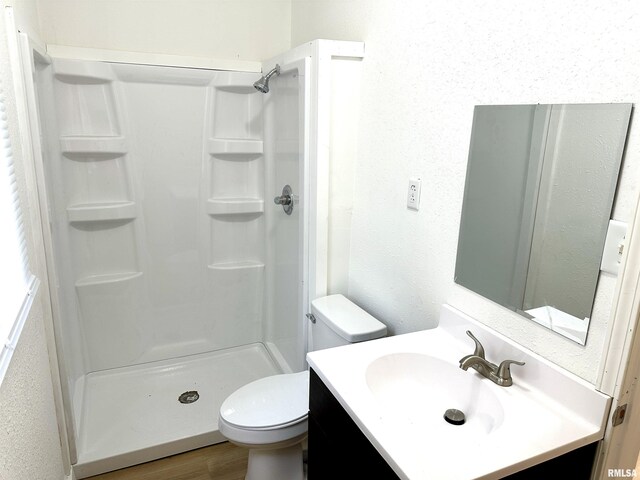 518 Noleman St, Centralia, IL 62801 - full bath featuring vanity, toilet, a stall shower, and wood finished floors