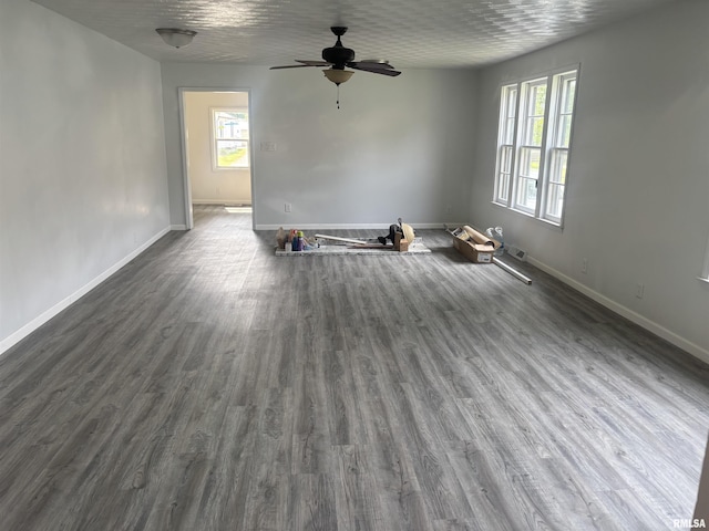 709 S Virginia St, Marion, IL 62959 - unfurnished living room with a ceiling fan, baseboards, and dark wood-style floors