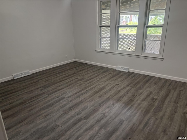 709 S Virginia St, Marion, IL 62959 - empty room with baseboards, plenty of natural light, and dark wood-style flooring