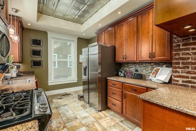 713 E Main St, Marion, IL 62959 - kitchen featuring a raised ceiling, a sink, baseboards, stainless steel refrigerator with ice dispenser, and light stone countertops