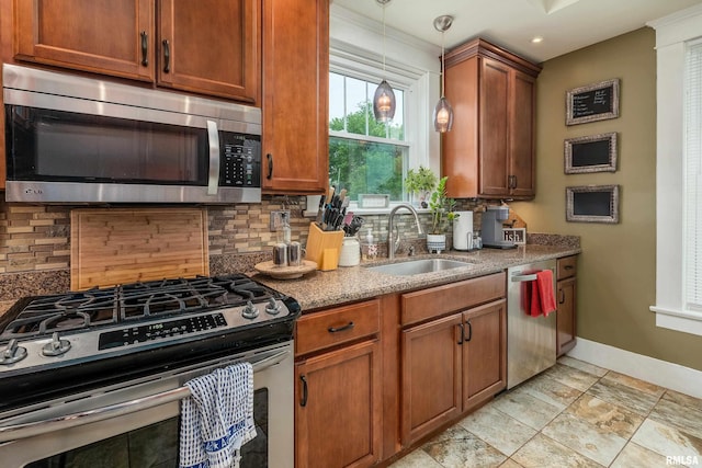 713 E Main St, Marion, IL 62959 - kitchen with appliances with stainless steel finishes, a sink, backsplash, baseboards, and stone counters
