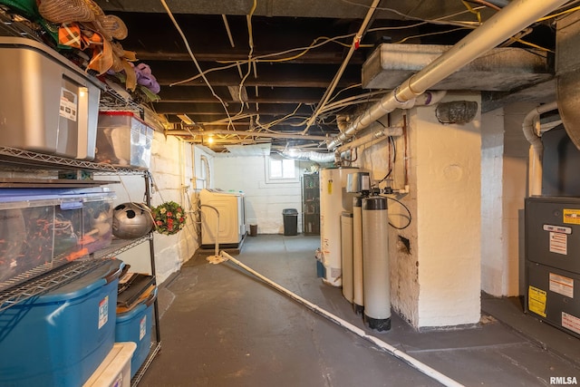 713 E Main St, Marion, IL 62959 - below grade area featuring gas water heater, a water softener, and washing machine and dryer