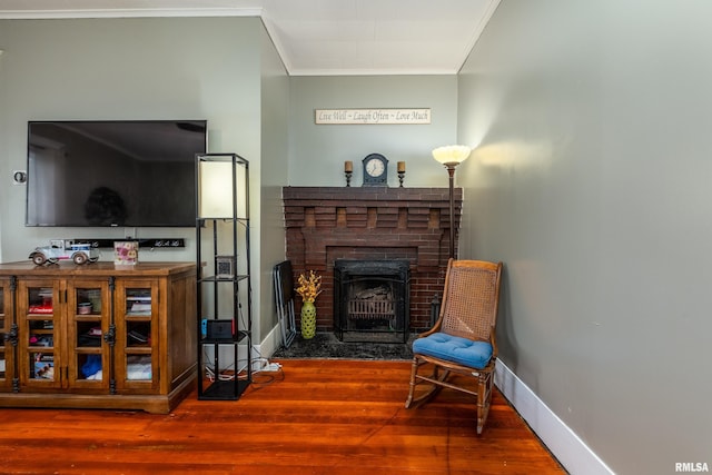 713 E Main St, Marion, IL 62959 - sitting room featuring crown molding, wood finished floors, a brick fireplace, and baseboards