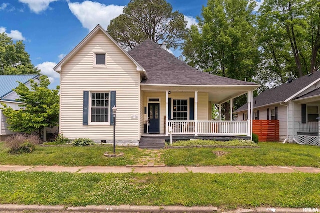 2112 Herbert St, Murphysboro, IL 62966 - view of front facade with covered porch, a front yard, and roof with shingles
