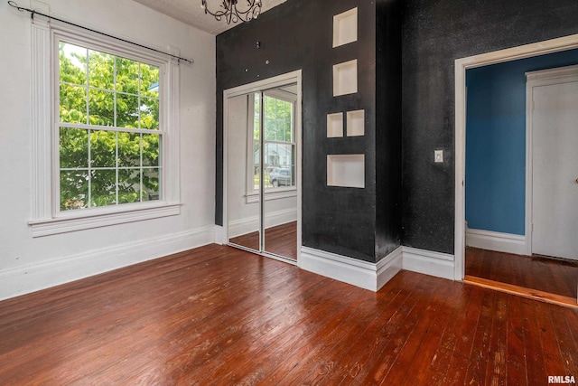 2112 Herbert St, Murphysboro, IL 62966 - unfurnished room with hardwood / wood-style flooring, baseboards, and a chandelier