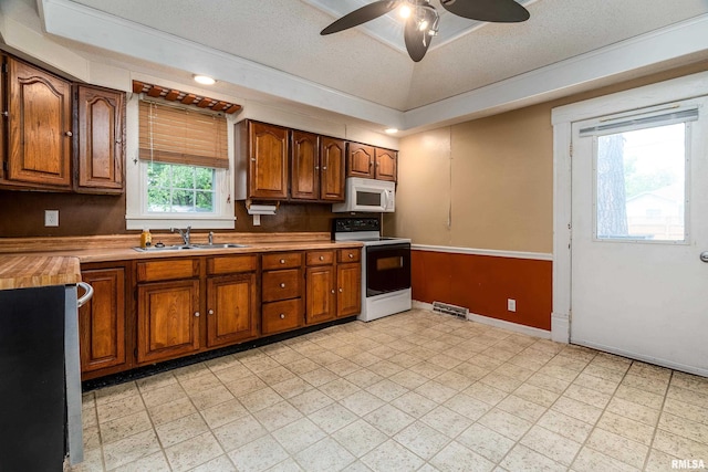2112 Herbert St, Murphysboro, IL 62966 - kitchen with white appliances, a sink, ceiling fan, baseboards, and brown cabinets