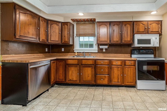 2112 Herbert St, Murphysboro, IL 62966 - kitchen with electric range oven, white microwave, a sink, stainless steel dishwasher, and brown cabinets
