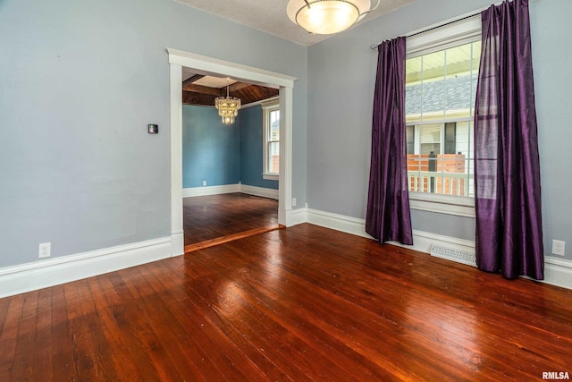 2112 Herbert St, Murphysboro, IL 62966 - unfurnished room featuring a chandelier, hardwood / wood-style floors, and baseboards