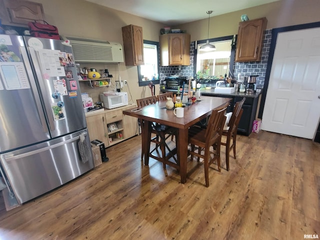 7324 State Route 161st Ext, Iuka, IL 62849 - kitchen with freestanding refrigerator, white microwave, wood finished floors, and tasteful backsplash