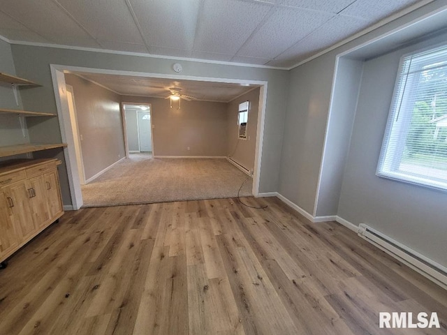 301 N Stotlar St, Benton, IL 62812 - unfurnished dining area with baseboard heating, a baseboard radiator, ornamental molding, light wood finished floors, and ceiling fan