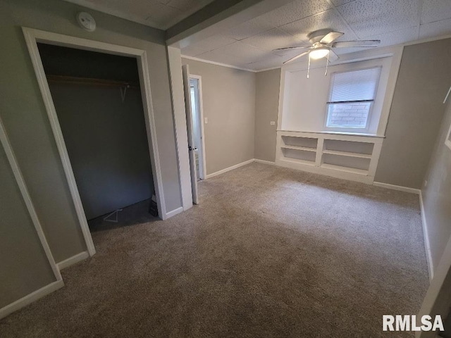 301 N Stotlar St, Benton, IL 62812 - unfurnished bedroom with carpet, a paneled ceiling, baseboards, a closet, and ceiling fan