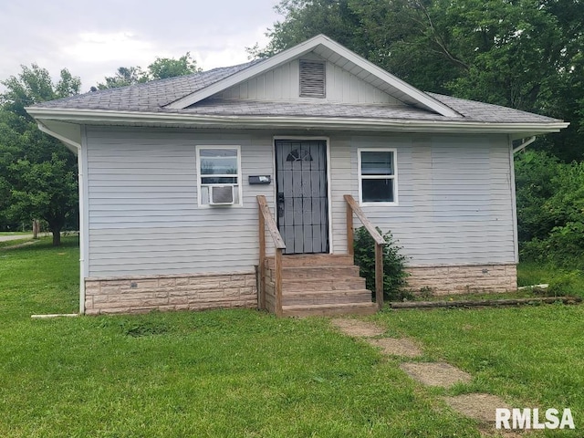 301 N Stotlar St, Benton, IL 62812 - bungalow with a front yard, a shingled roof, cooling unit, board and batten siding, and entry steps