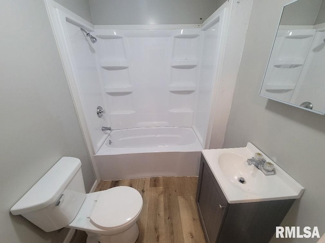 301 N Stotlar St, Benton, IL 62812 - full bathroom with wood finished floors, vanity, toilet, and bathing tub / shower combination