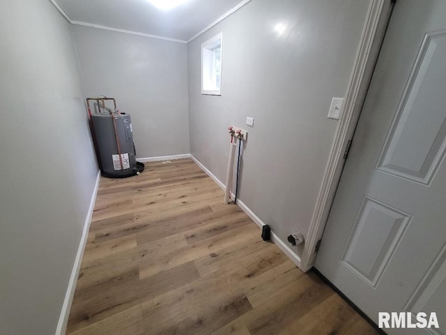 301 N Stotlar St, Benton, IL 62812 - laundry area with ornamental molding, water heater, light wood-style flooring, and baseboards