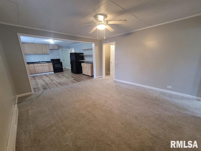 301 N Stotlar St, Benton, IL 62812 - unfurnished living room with light carpet, ceiling fan, and baseboards