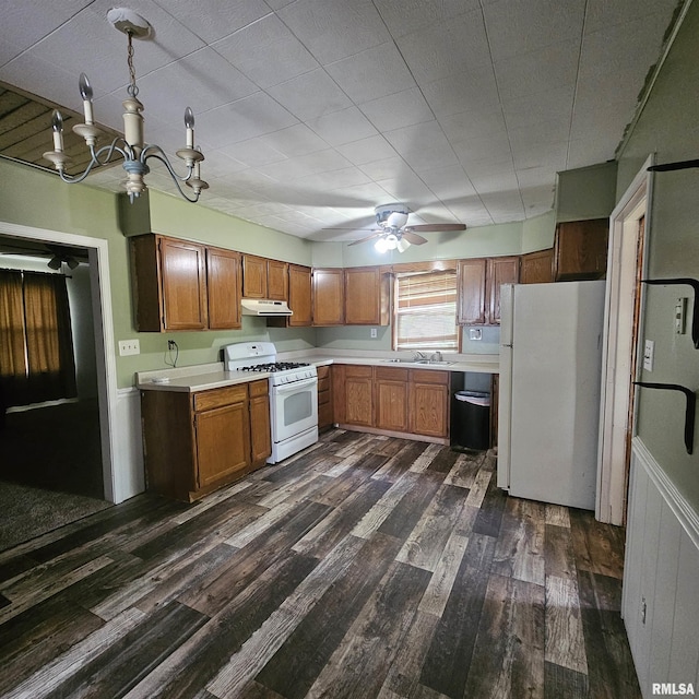 111 Rufus, Mount Vernon, IL 62864 - kitchen with white appliances, under cabinet range hood, light countertops, brown cabinetry, and a sink