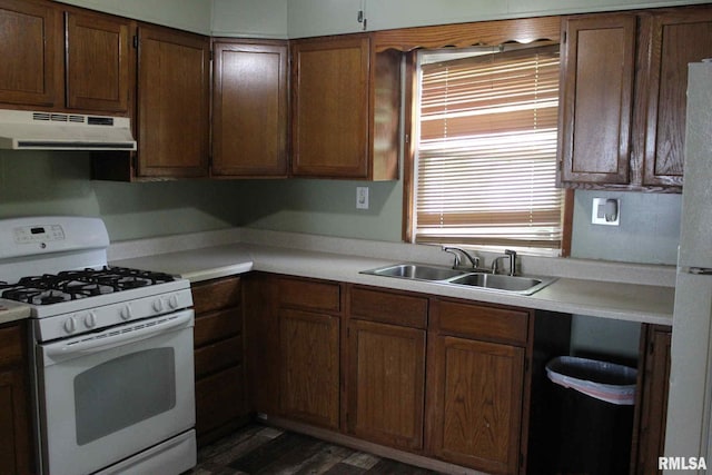 111 Rufus, Mount Vernon, IL 62864 - kitchen with white appliances, under cabinet range hood, a sink, light countertops, and dark wood-style flooring