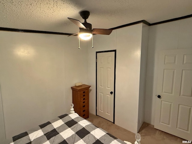 2000 Simmons St, Metropolis, IL 62960 - unfurnished bedroom featuring light carpet, crown molding, a textured ceiling, and a ceiling fan