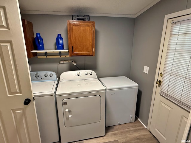 2000 Simmons St, Metropolis, IL 62960 - washroom with cabinet space, washer and clothes dryer, light wood finished floors, ornamental molding, and baseboards