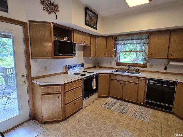 2998 Massac Creek Rd, Metropolis, IL 62960 - kitchen with black appliances, light countertops, open shelves, and brown cabinets