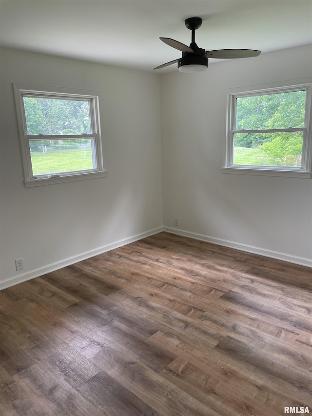 208 Dorris Dr, Metropolis, IL 62960 - empty room with healthy amount of natural light, wood finished floors, a ceiling fan, and baseboards