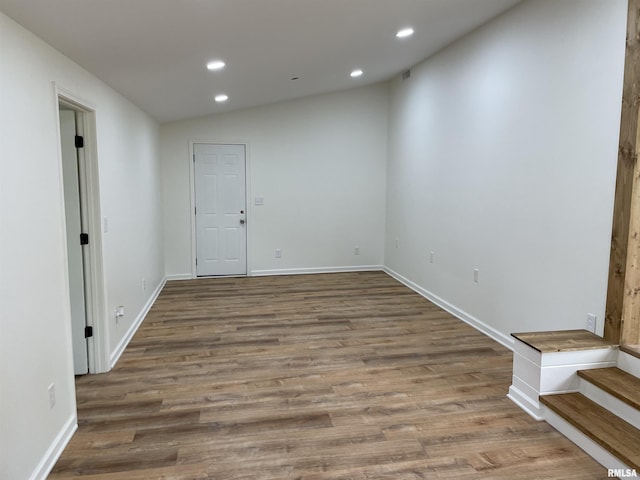 208 Dorris Dr, Metropolis, IL 62960 - spare room featuring recessed lighting, wood finished floors, lofted ceiling, baseboards, and stairs