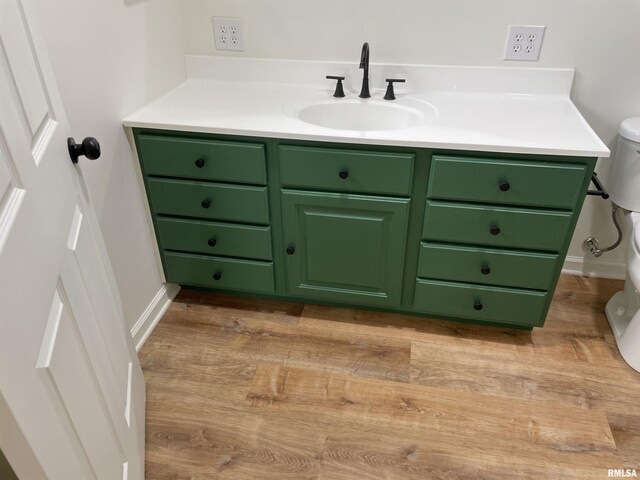 208 Dorris Dr, Metropolis, IL 62960 - bathroom featuring toilet, vanity, wood finished floors, and baseboards