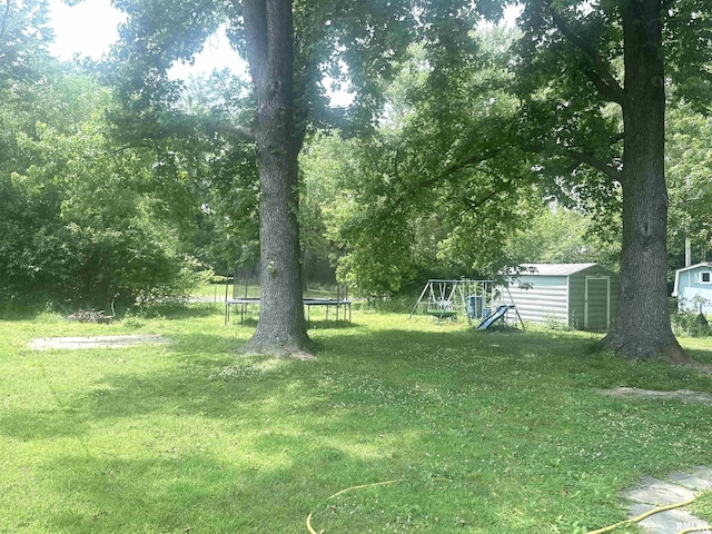 1008 N Norwest Ln, Carbondale, IL 62901 - view of green lawn with a trampoline and a playground