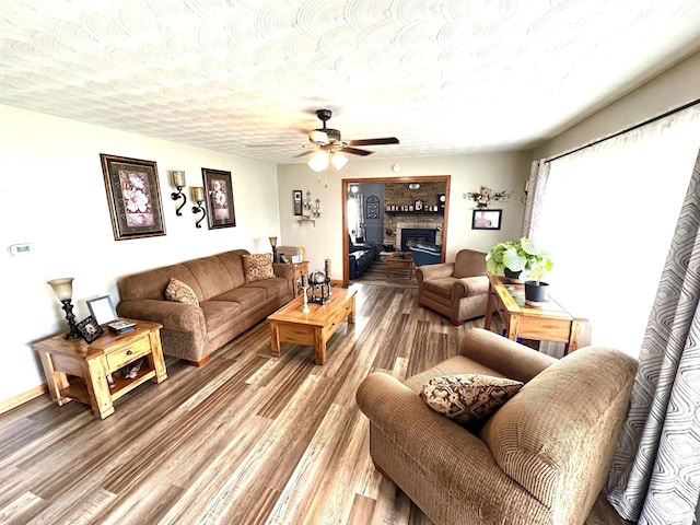 118 W 5th St, Hoffman, IL 62250 - living area featuring ceiling fan, wood finished floors, a glass covered fireplace, and a textured ceiling