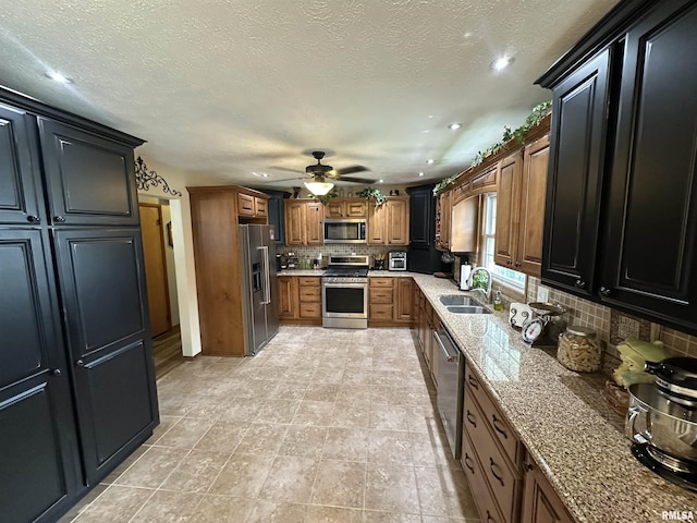 118 W 5th St, Hoffman, IL 62250 - kitchen featuring appliances with stainless steel finishes, a sink, recessed lighting, decorative backsplash, and light stone countertops