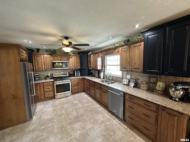 118 W 5th St, Hoffman, IL 62250 - kitchen with appliances with stainless steel finishes, a sink, decorative backsplash, a ceiling fan, and recessed lighting