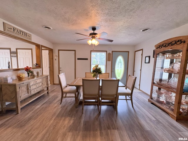 112 Townhouse Dr, Carterville, IL 62918 - dining room featuring wood finished floors, a textured ceiling, and a ceiling fan
